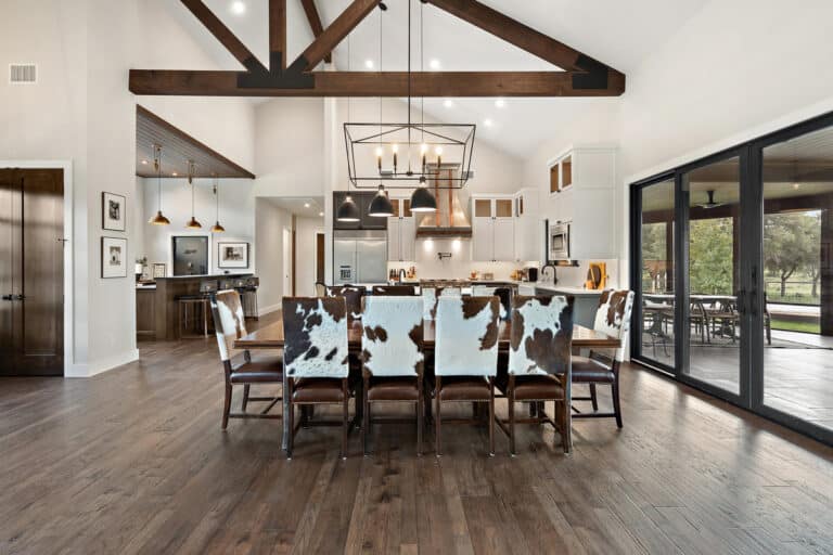 A spacious kitchen featuring wood floors and a cowhide chair, located in Austin, TX