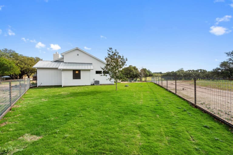 A white house with a yard enclosed by a fence was found in Austin, TX