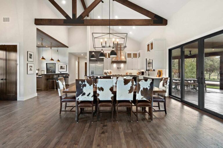A spacious kitchen with wooden floors and a cowhide chair, located in Cherokee Creek, Texas
